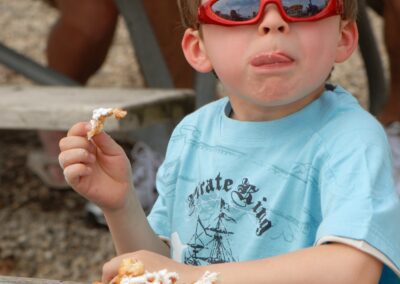 Boy with red glasses eating